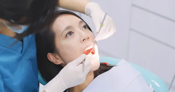 A patient receiving a professional cosmetic dentistry examination in Clementi