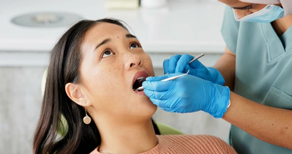 A patient receiving dental examination for tooth extraction