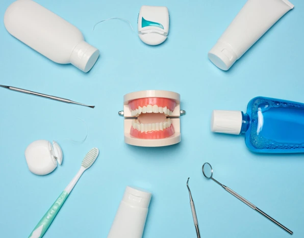 Assortment of dental hygiene products including toothbrush, floss, and toothpaste for preventing tooth damage