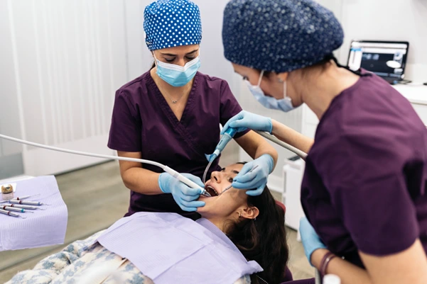  Dentist at Clementi carefully performing a dental examination on a new patient