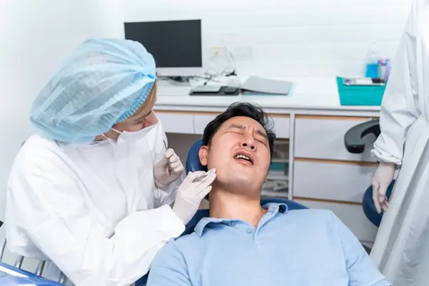 A patient receiving urgent treatment from an emergency dentist at Ginza Dental clinic in Clementi