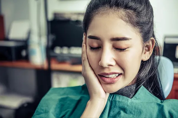 A woman suffering from a severe toothache